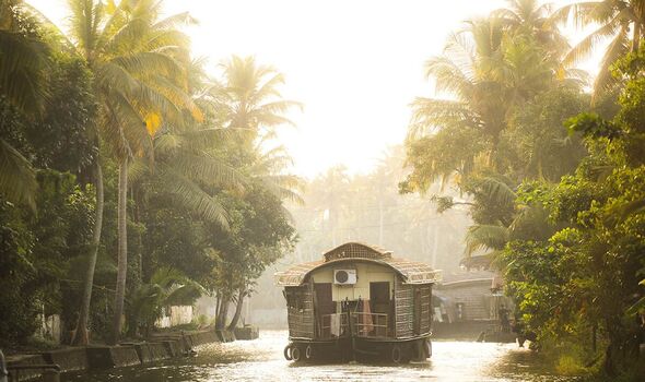 Excursion en bateau touristique en péniche lors d'une excursion dans les backwaters du Kerala au coucher du soleil