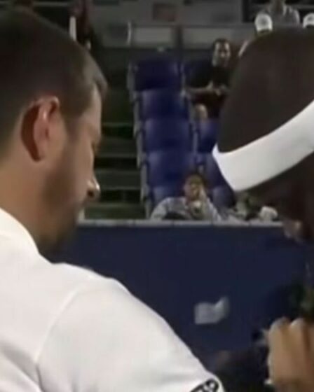 Le match de tennis est brusquement retardé alors que l'arbitre tire sur le maillot du joueur et que la foule hue bruyamment